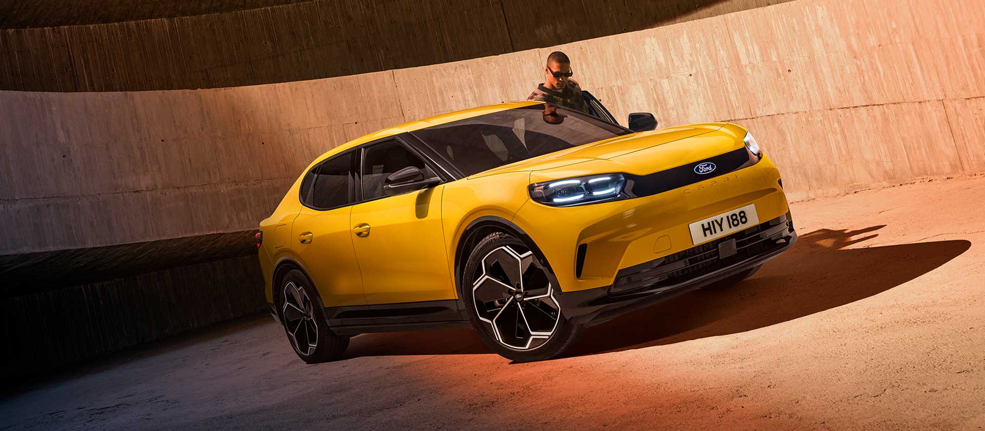 A new yellow Ford Capri® electric SUV parked in a car park.